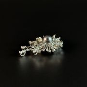 Elegant and eye-catching grey pearl sunburst brooch